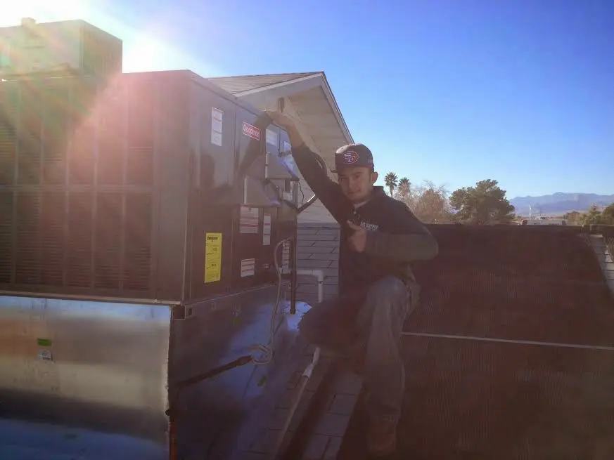 HVAC technician performing Boiler Repair on a rooftop unit in Newington Forest